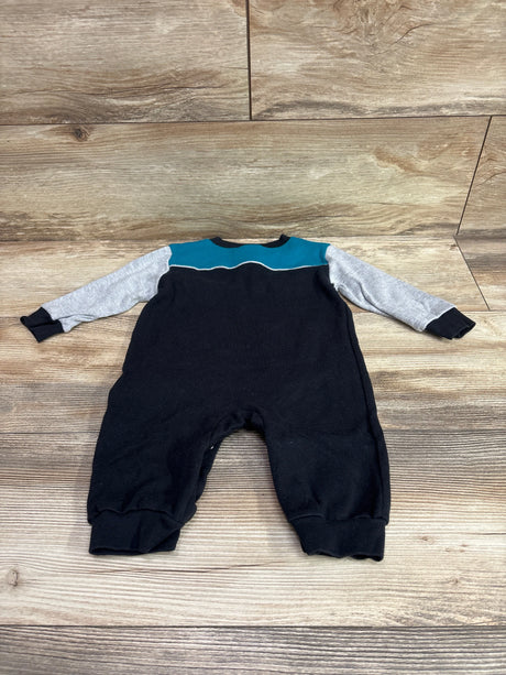 Front view of NFL Team Apparel Jaguars coverall in size 6 to 9 months showcasing gray sleeves and teal yoke on wood flooring