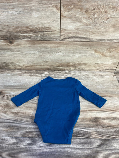 Flat lay of blue Nike long-sleeve baby bodysuit showing back on light wood background