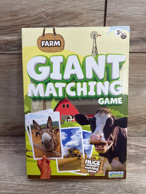 Front view of PlayMonster Giant Matching Game box (Farm) showing large GIANT MATCHING GAME title, cow and donkey images on wood background