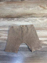 Tan ribbed baby leggings on wood floor, kids clothing resale
