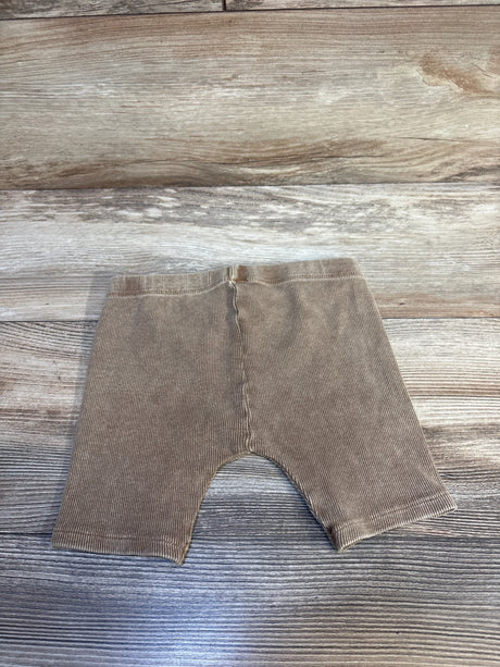 Tan ribbed baby leggings on wood floor, kids clothing resale