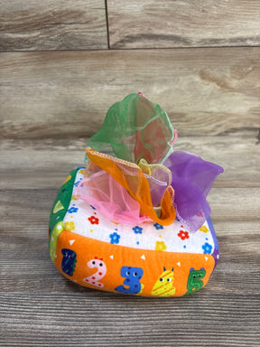 Front view of Soft Felt Montessori tissue box showing numbered orange side and multicolored sheer scarves pulled from the top on wooden surface