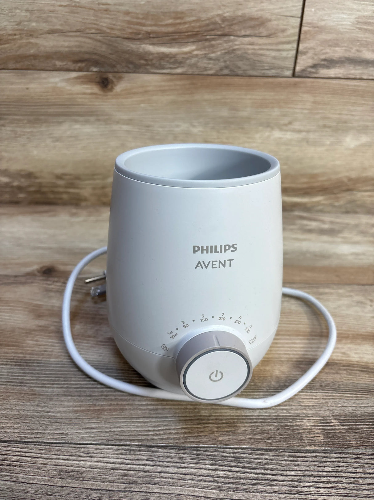 Philips Avent bottle warmer on wooden surface, ideal for baby gear and maternity needs