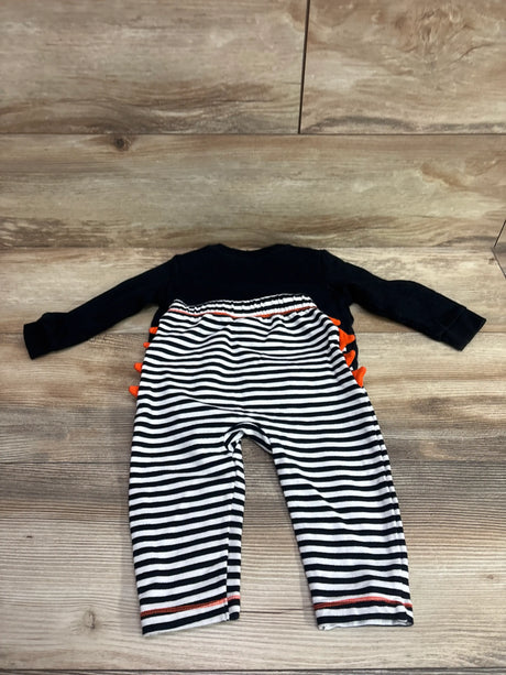 Flat lay of Cat & Jack Milk Monster sweatshirt and joggers set with striped pants and orange accents on wood flooring
