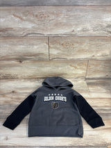 Kids Vegas Golden Knights hoodie, gray with black sleeves, laid on wood floor