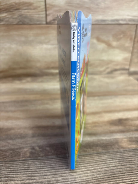 Baby Einstein Farm Friends video fun book standing on wooden surface, children's educational toy