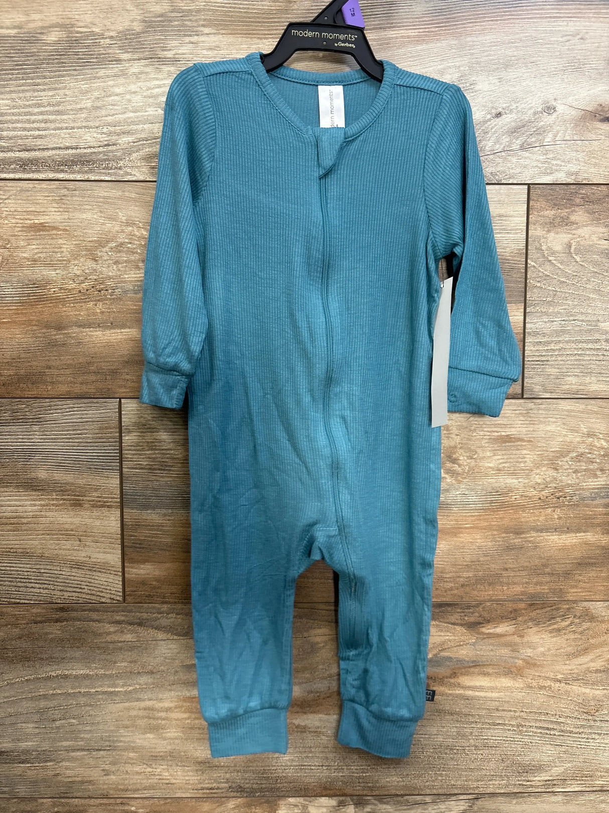 Front view of Modern Moments ribbed footless sleeper, blue 12M, showing full-length zipper and cuffed sleeves on wood background