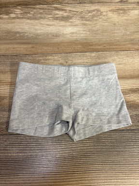 Flat lay of Tucker + Tate grey toddler bike shorts size 2T showing elastic waistband and soft cotton knit on wood background