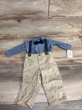 Baby boy outfit with blue shirt, navy bow tie, suspenders, and anchor print khaki pants on wood floor