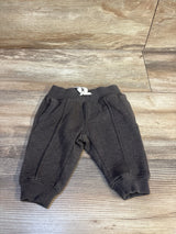 Dark gray toddler joggers with white drawstring, laid on wood floor — kids clothing resale