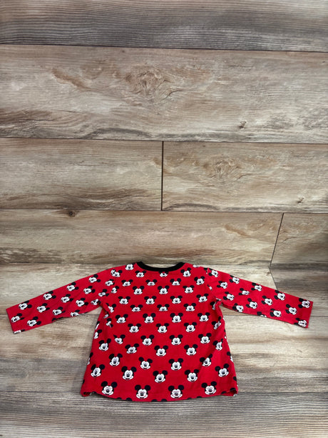 Red long sleeve toddler shirt with all-over Mickey Mouse print on a wood background