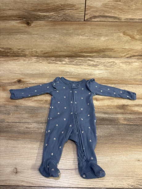 Front view of Carter’s blue ribbed sleeper in preemie size with long sleeves, footed legs, and zip closure on wood flooring