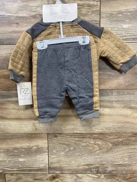 RZ Baby by Rachel Zoe two-piece baby outfit with tan quilted sleeves and gray pants on wooden floor
