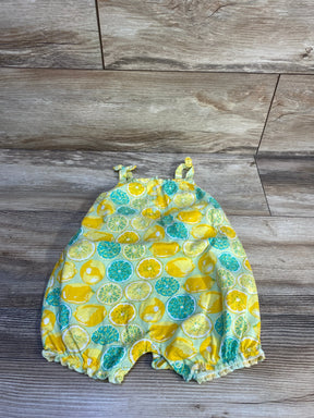 Top-down view of Henley lemon tank romper showcasing lemon print, knotted shoulder straps and snap crotch on wood floor