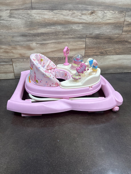 Front view of Disney Music and Lights Baby Walker showcasing pink floral seat and activity toys on wood backdrop