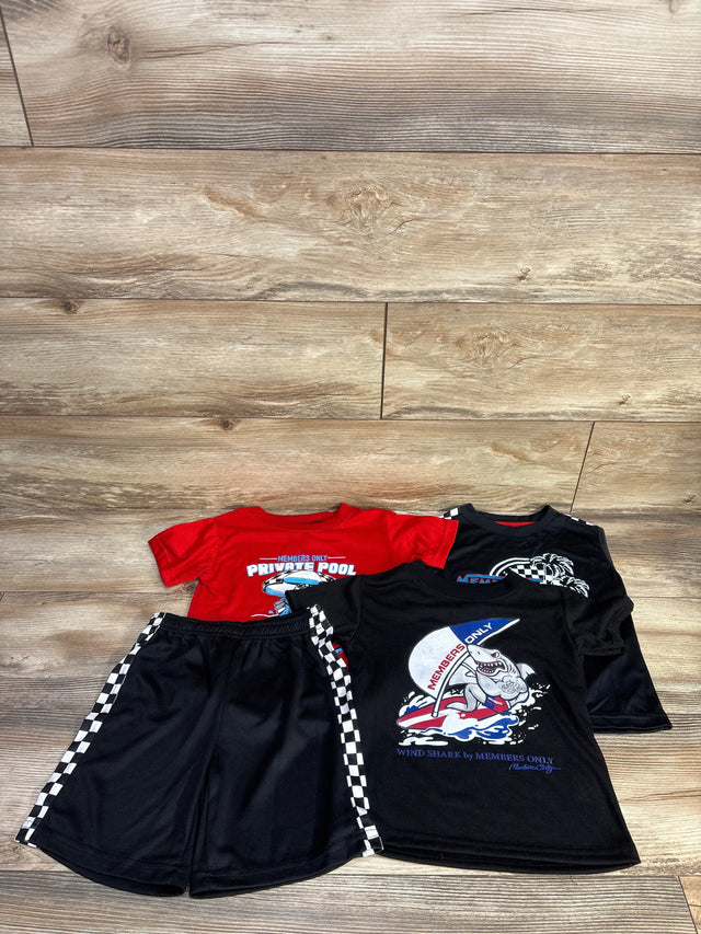 Flat lay of 4-piece toddler shirt and short set with shark graphic tees and checkered-stripe black shorts on wood floor