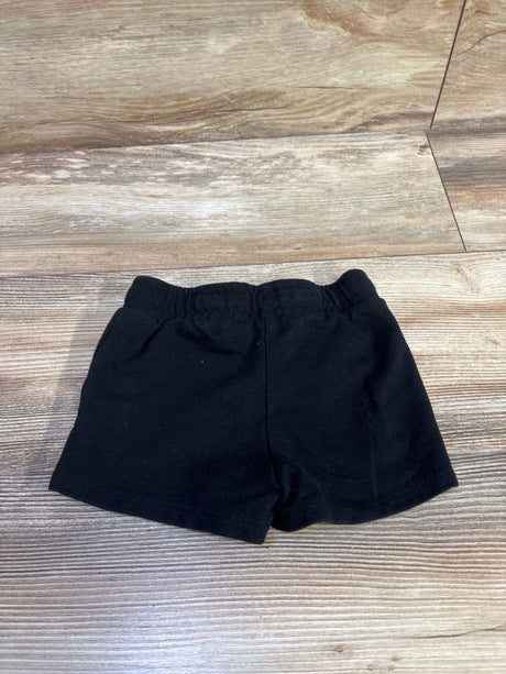 Flat lay of Cat and Jack black knit toddler shorts showing elastic waistband and short inseam on wood floor background