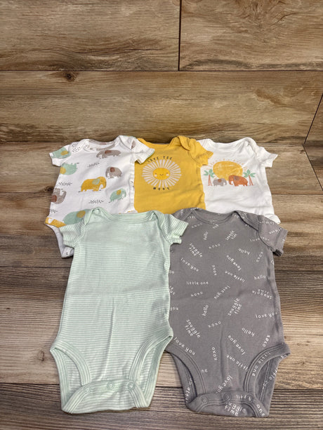 Top view of Carter’s 5 pack bodysuits in varied colors and patterns, size 3 months, on a wood surface