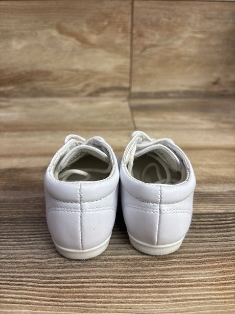 Rear view of white Josmo lace-up walking dress shoes showcasing stitched heel panels on a wood-grain surface