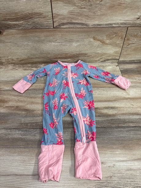 Top view of a blue floral bamboo convertible sleeper with pink trim and foldover cuffs on a wood floor