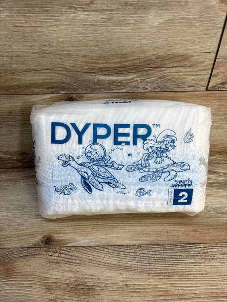 Dyper Smurfy White size 2 eco-friendly diapers with Smurfs design on wooden surface