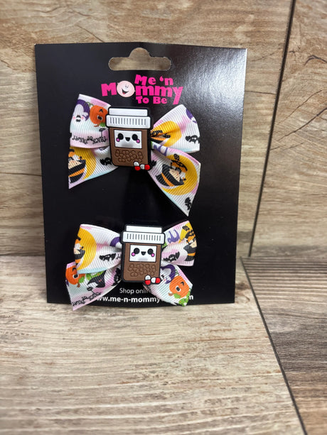 Front view of coffee applique hair bows 2pk showcasing two colorful printed bows on a black display card