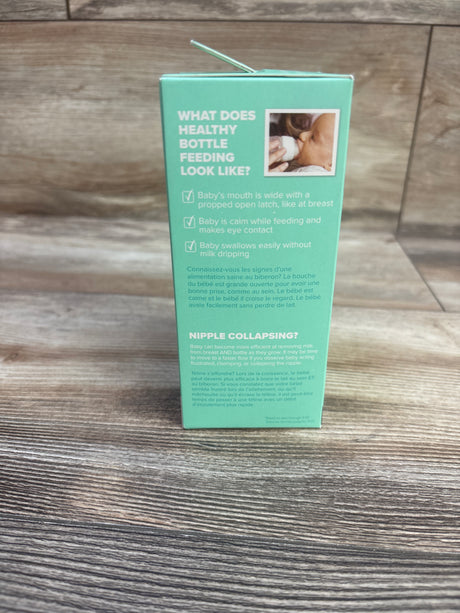 Back view of NEW Evenflo Balance+ Wide Neck Baby Bottles box showing healthy bottle feeding guidance on wood surface