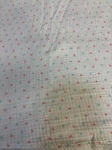 Soft polka dot baby blanket with red and teal dots on white fabric, ideal for newborns and toddlers.