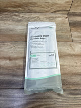 Top view of Motif 7-pack microwave steam sterilizer pouch showing front label (up to 20 uses) and use-count marks on wood background