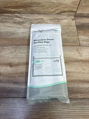 Top view of Motif 7-pack microwave steam sterilizer pouch showing front label (up to 20 uses) and use-count marks on wood background