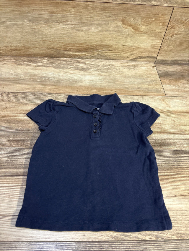 Children's Place navy blue short sleeve polo shirt for toddlers, size 3T, on a wood floor.