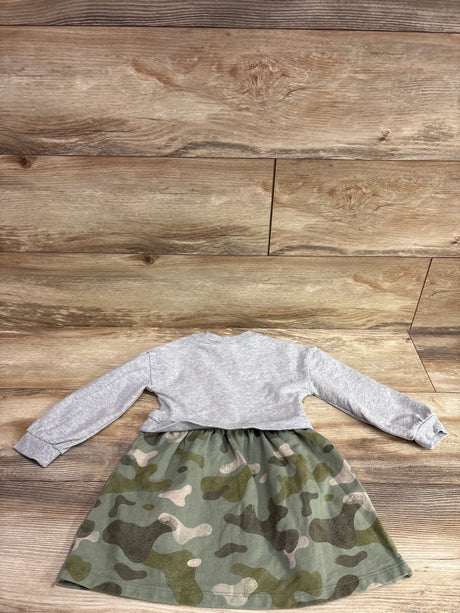 Front view of Carter’s grey sweatshirt dress with a camouflage-print skirt laid on a wood floor