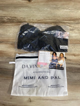 Black nursing and pumping bra in clear packaging with white Davin and Adley cloth bag, promotional card on wood surface