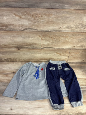Children's gray long sleeve shirt with blue polka dot tie and blue pants with pockets on wooden floor