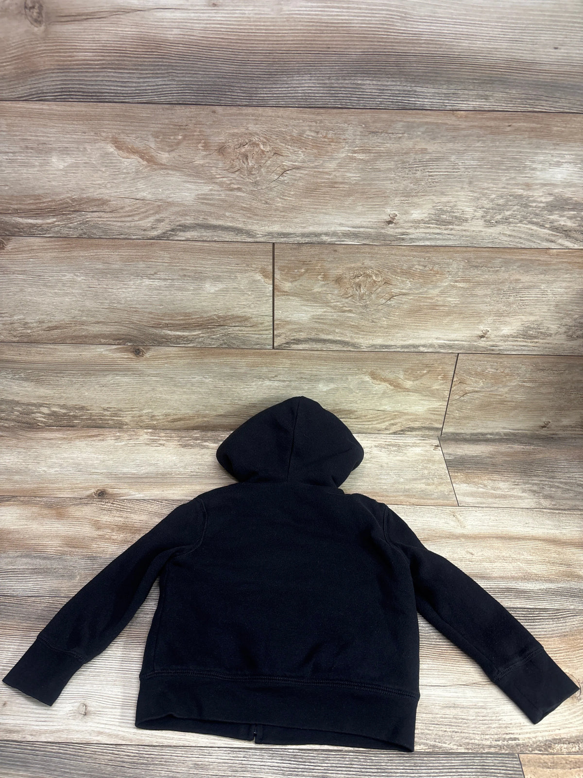 Back view of Gap Kids logo sherpa-lined zip hoodie in black, size 4 to 5, with hood on a wood floor