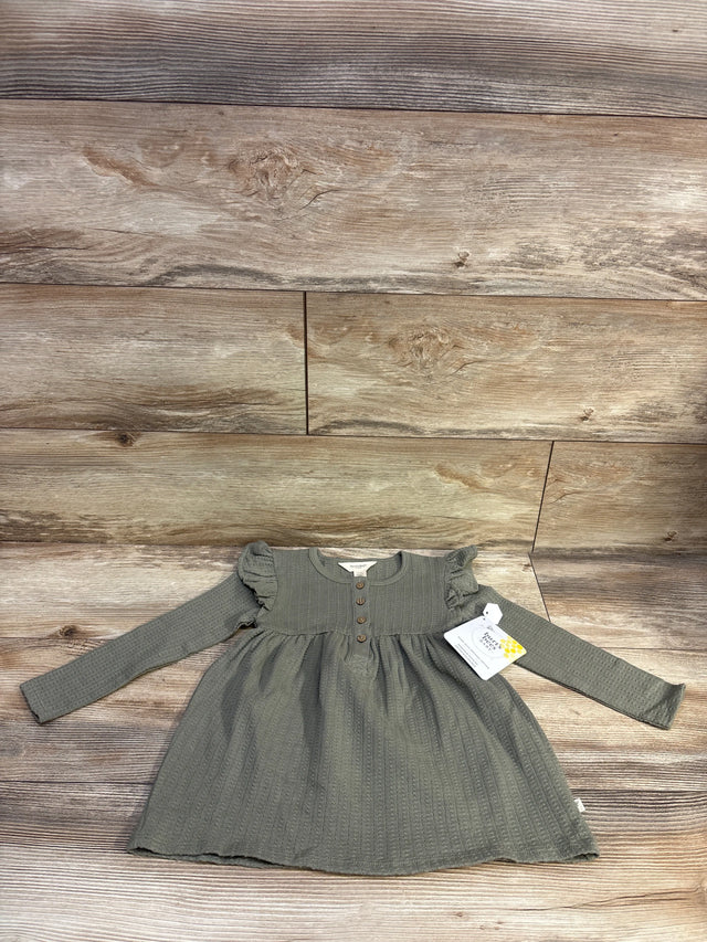 Green long sleeve tunic dress for toddlers by Me n Mommy To Be on a wood background