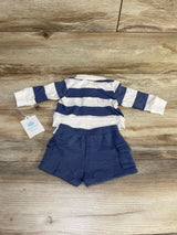 Flat lay of Cloud Island newborn 2-piece: blue and white striped polo top and solid navy shorts on wood background