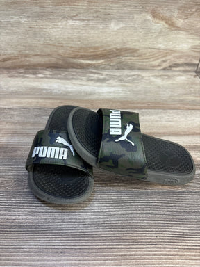 Kids camo Puma slide sandals with logo on wooden background, gently used condition