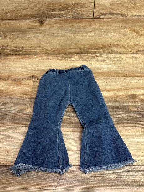 Front view of Psainyal bell-bottom jeans in blue showcasing elastic waistband, flared legs, and frayed hems on a wood floor