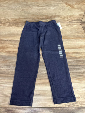 Flat lay of Carter's navy chambray toddler jeggings size 5T showing elastic waistband and slim leg on wood floor