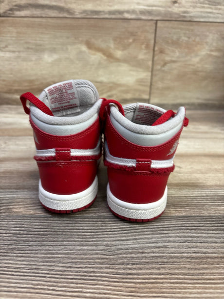 Rear view of Air Jordan 1 Retro High OG TD Newstalgia Chenille sneakers showcasing red and white panels on wood flooring