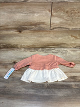 Baby long sleeve pink and white dress on wooden background, resale kids clothing