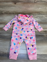 Pink baby hooded romper with colorful heart pattern on wood floor