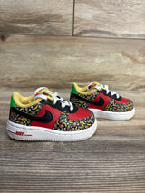 Kids Nike Air Force 1 sneakers with fruit print, red black white design, toddler shoes on wood floor