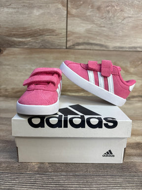 Pink Adidas toddler sneakers with velcro straps on box