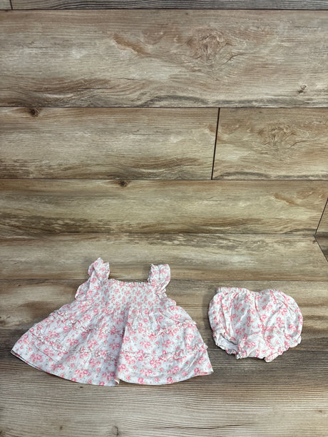 Flat lay of Janie & Jack Emily floral smocked two-piece set with ruffle straps and matching bloomers on wood background