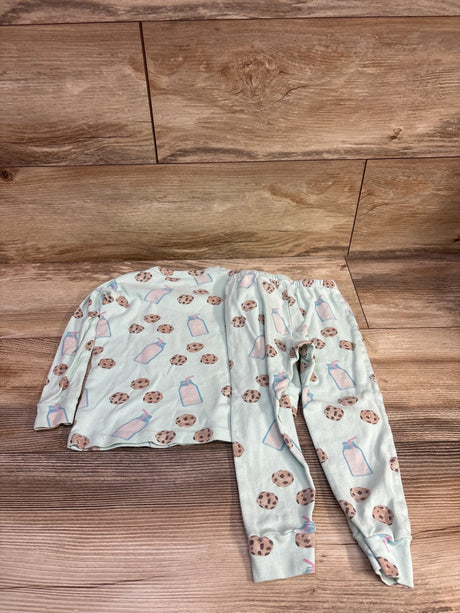 Flat lay of Monica and Andy 2pc Cookies and Milk pajama set in mint, size 3T, with cookie and milk bottle print on wood