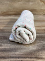 Soft baby swaddle blanket with pink and teal polka dots, ideal for newborns and infants