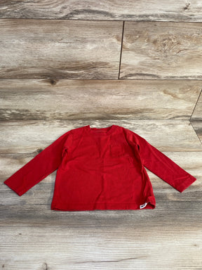 Front flat lay of Baby Gap red long-sleeve toddler shirt showing left chest pocket and crewneck on wood floor background