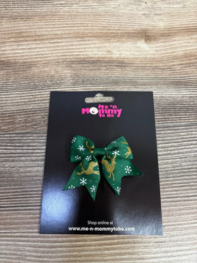 Green holiday bow with gold reindeer and snowflakes for kids' festive hair accessory